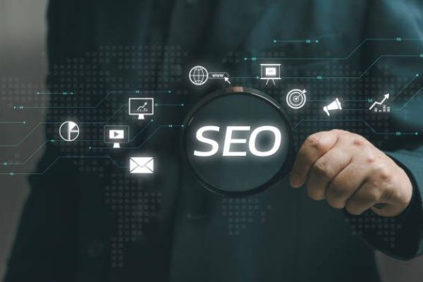 istockphoto-1901483798-612×612 man holds a magnifying glass to search tools for SEO Marketing. SEO strategy that uses customizing and optimizing the website or content of that online business so that it can rank on search engines.